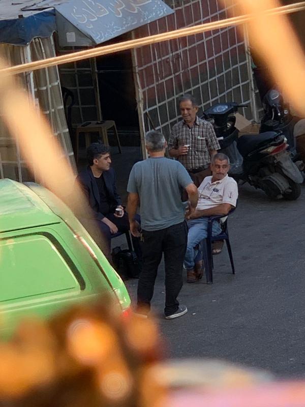صورة لمعالي وزير الاشغال العامة والنقل الدكتور حمية يجلس على الطريق ويسمع هموم المواطنين